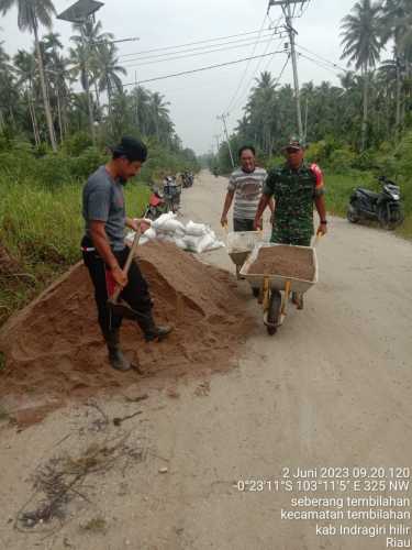 Sertu M.yasin ajak warga gotong royong nimbun jalan desa