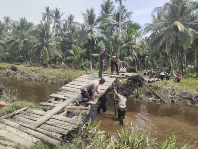 Polsek Enok Bersama Masyarakat Perbaiki Jembatan Dusun Sei Intan Wujud Kepedulian Terhadap Warga